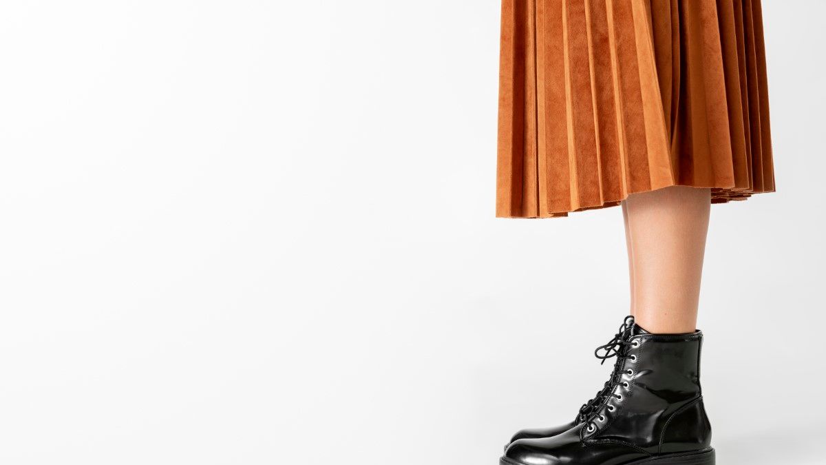 Woman in a skirt wearing combat boots
