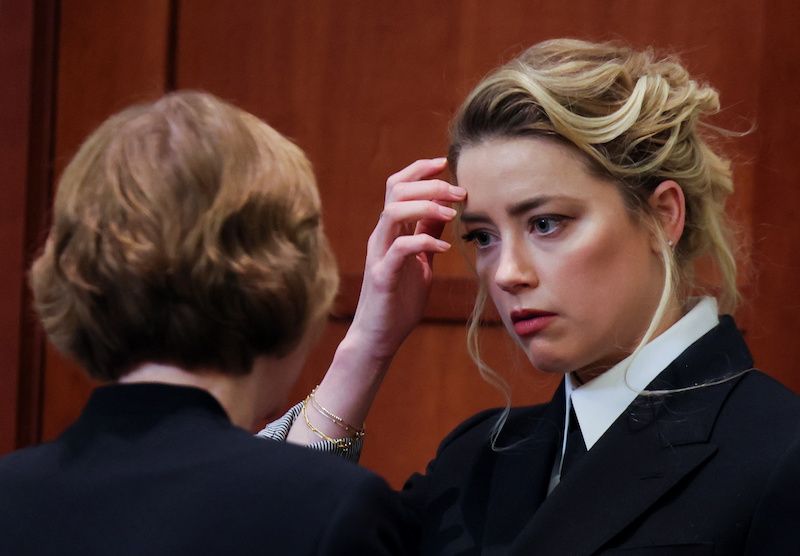 Actor Amber Heard speaks with a member of her legal team as she attends Johnny Depp's defamation trial against her at the Fairfax County Circuit Courthouse in Fairfax, Virginia, U.S., April 13, 2022.,Image: 682583714, License: Rights-managed, Restrictions: , Model Release: no, Credit line: EVELYN HOCKSTEIN / Reuters / Forum