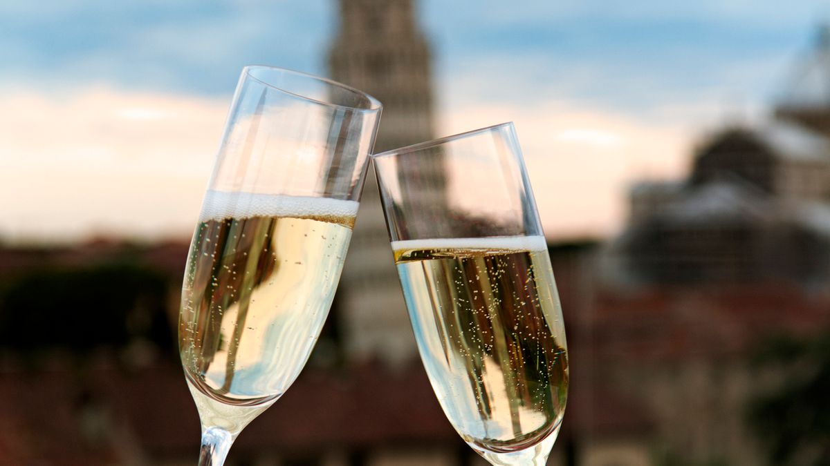 Two glasses of champagne with the Tower of Pisa in the background