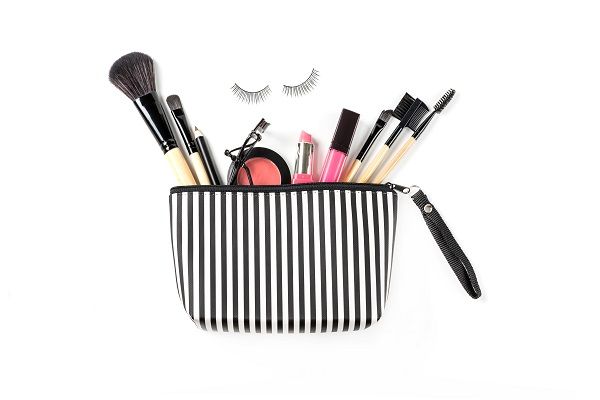 Make up bag with various cosmetics and brushes isolated on white background, Top view, Beauty concept