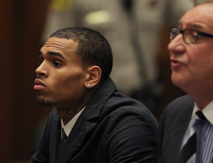 R&B singer Chris Brown (L) appears in court with his attorney Mark Geragos for a probation progress report hearing in Los Angeles on February 6, 2013. Brown pleaded guilty to assaulting his girlfriend, singer Rihanna, after a pre-Grammy Awards party in 2009. Prosecutors have alleged that he has failed to meet the terms of his probation. UPI/David McNew/pool (Newscom TagID: upiphotostwo220515.jpg) [Photo via Newscom]