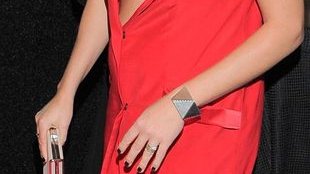 Postrzępione spodnie i dekolt obnażający ciążowy brzuszek